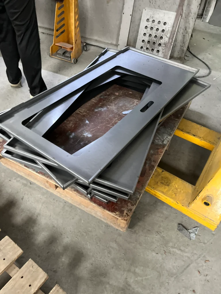 Large laser cut steel panels with cable entry openings for industrial electrical enclosures