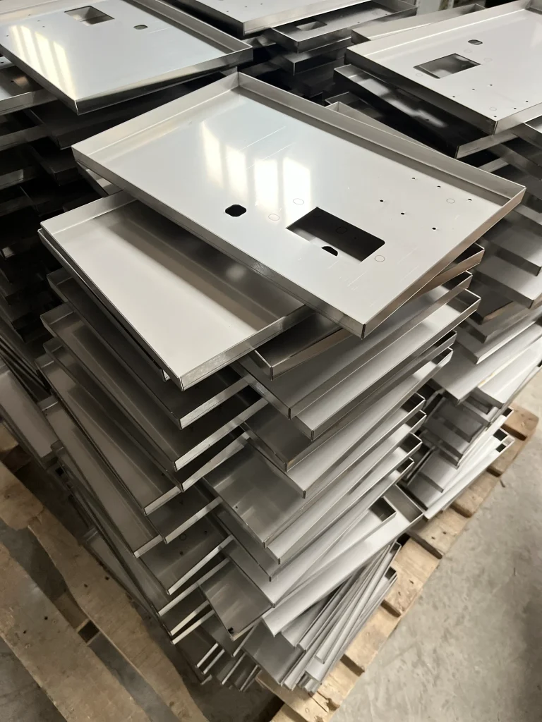 Laser cut electrical enclosure panels stacked after batch production with precise cutouts