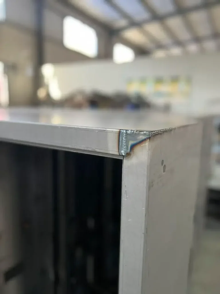 Welded corner of electrical enclosure showing clean weld seam and structural strength