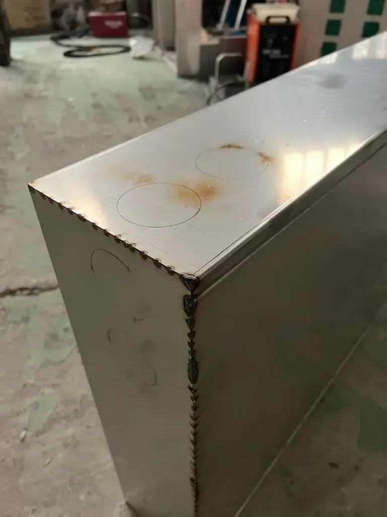 Sheet metal welding seam detail for enclosure fabrication with minimal deformation